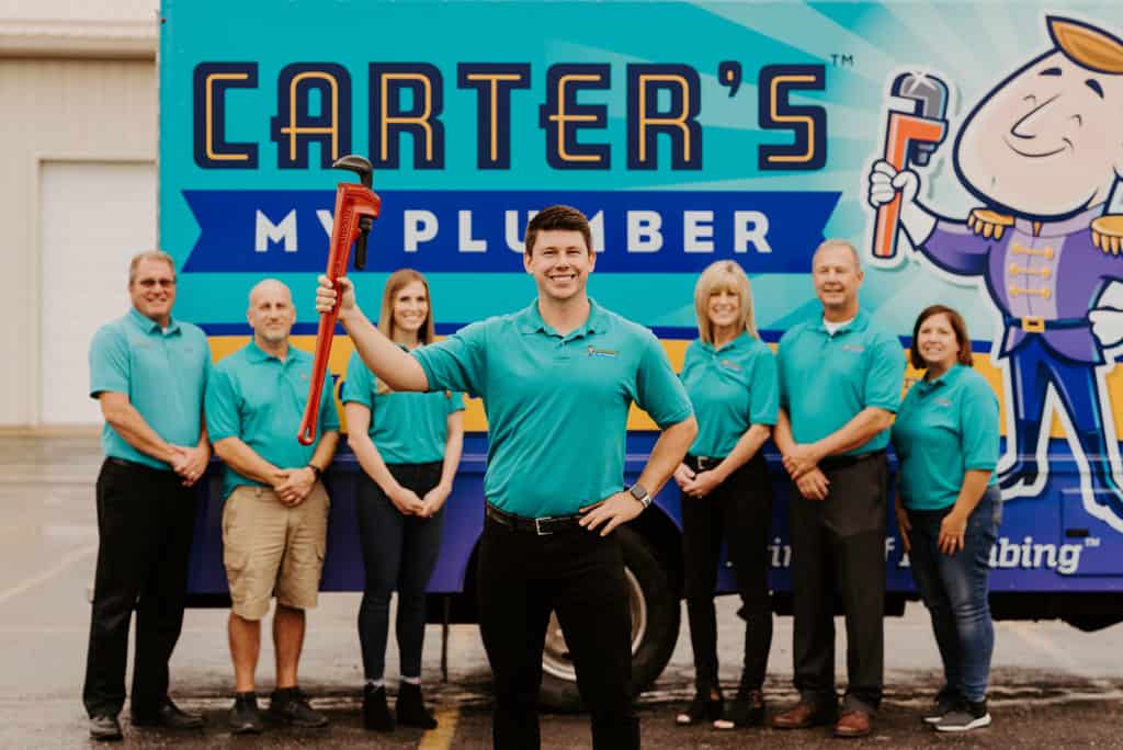 Plumber team with plumber holding a tool